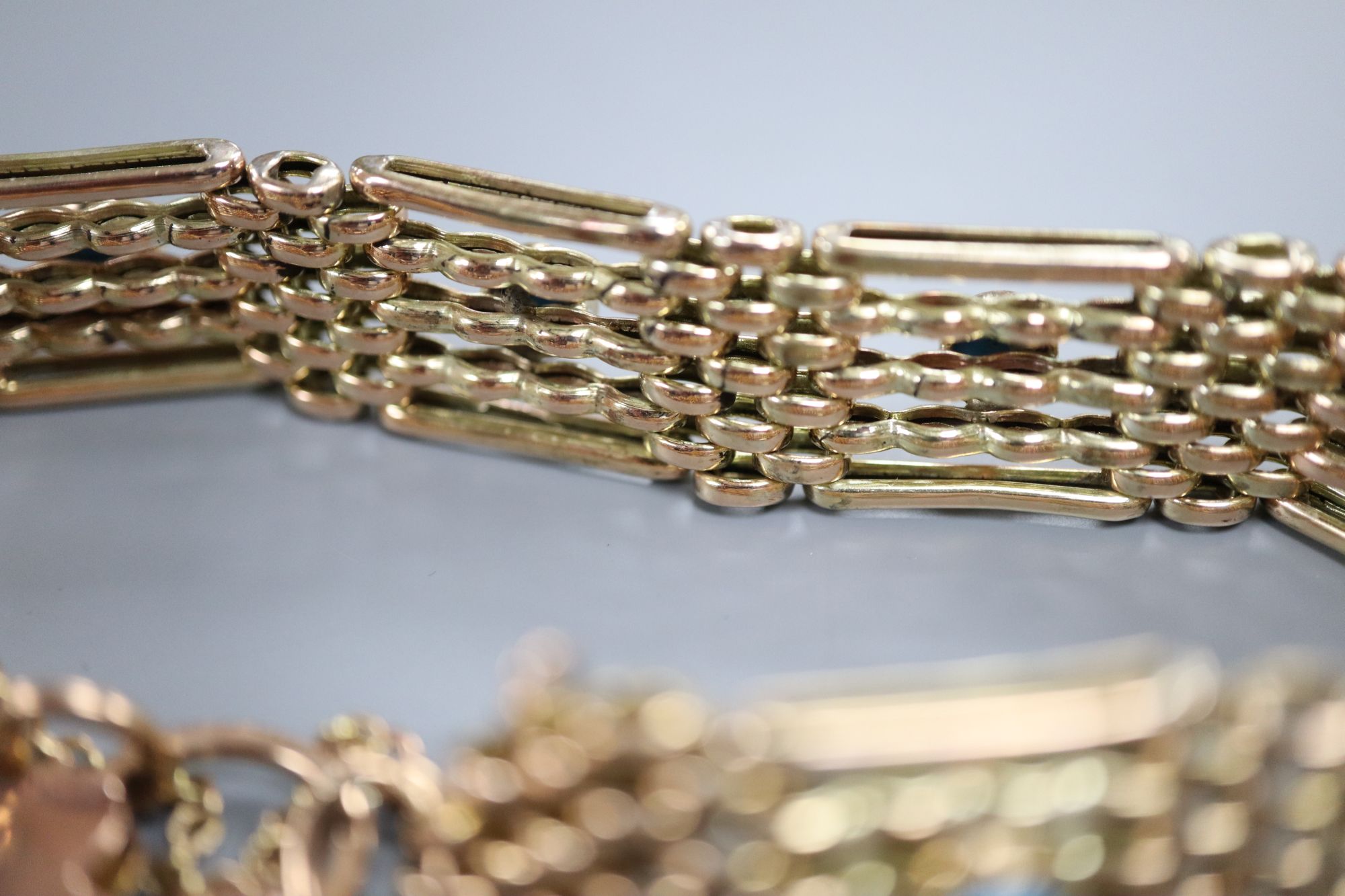 An early 20th century 9ct and seven stone turquoise set gatelink bracelet, approx. 18cm, gross 18.8 grams.